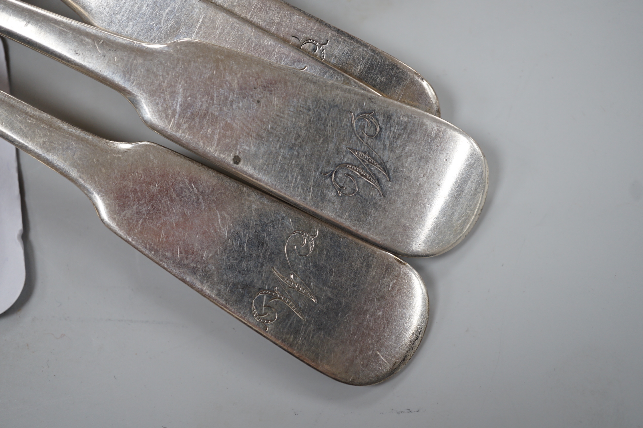 A set of nine early 19th century Scottish provincial silver fiddle pattern dessert spoons, 18.5cm and a pair of sauce ladles, by Alex MacLeod, Inverness, 11oz.